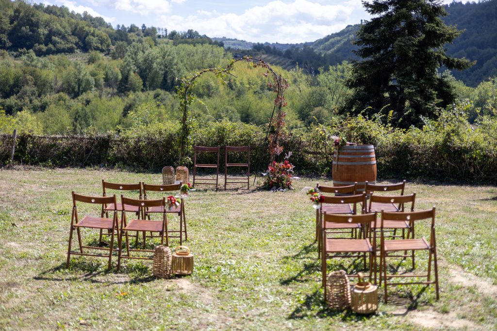 Ceremonieopstelling met stoelen en bloemen in het Italiaanse landschap