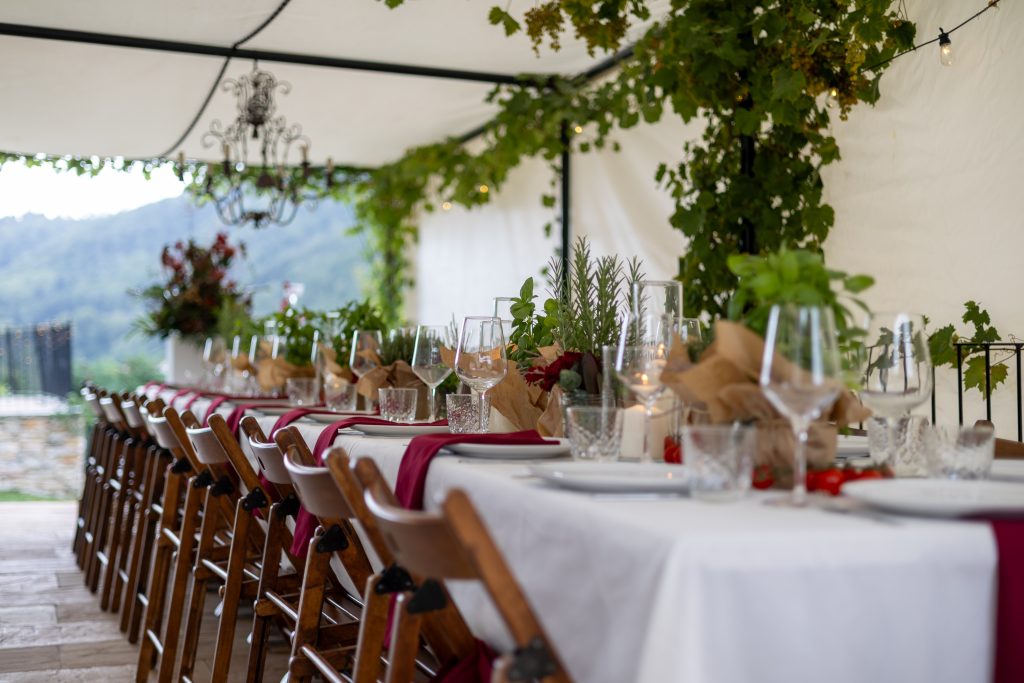 Gedekte trouwtafel met rode details bij de styled shoot in Italië